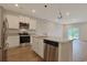 Modern kitchen with stainless steel appliances, granite countertops, and an island overlooking the living area at 184 Sea Shell Dr. # 12, Murrells Inlet, SC 29576