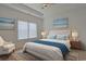 Bright main bedroom with tray ceiling, beach art, and a large window at 184 Sea Shell Dr. # 12, Murrells Inlet, SC 29576