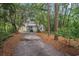 View of the back of the home nestled in a wooded lot at 1930 Lake View Circle, Myrtle Beach, SC 29575