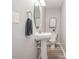 Bathroom featuring a pedestal sink, oval mirror, and wood look flooring at 1930 Lake View Circle, Myrtle Beach, SC 29575