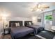 Cozy bedroom featuring two beds, wood-look floors, ceiling fan and bright window at 1930 Lake View Circle, Myrtle Beach, SC 29575