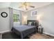Bedroom with wood-look floors, a ceiling fan, and a bright window at 1930 Lake View Circle, Myrtle Beach, SC 29575