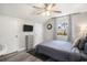 Bedroom with wood-look floors, ceiling fan, and natural light from the window at 1930 Lake View Circle, Myrtle Beach, SC 29575