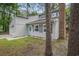 Charming home exterior with a blue front door, manicured lawn, and mature trees at 1930 Lake View Circle, Myrtle Beach, SC 29575