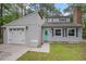 Charming home with a well-maintained front yard, attached garage, and light blue front door at 1930 Lake View Circle, Myrtle Beach, SC 29575