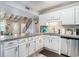 Bright kitchen features granite countertops, white cabinets, and stainless steel dishwasher at 1930 Lake View Circle, Myrtle Beach, SC 29575