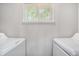 Bright laundry room features a window and side-by-side washing machines at 1930 Lake View Circle, Myrtle Beach, SC 29575