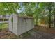 Outdoor storage shed with weathered siding, nestled among the trees at 1930 Lake View Circle, Myrtle Beach, SC 29575