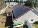 This aerial shot showcases solar panels, and a fenced in yard with recreational equipment at 200 Silverbelle Blvd., Longs, SC 29568