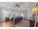 Cozy bedroom features a tray ceiling, ceiling fan, and a beautiful wood-framed bed at 200 Silverbelle Blvd., Longs, SC 29568
