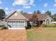 Charming single-story home with a well-manicured lawn, attached garage, and inviting front walkway at 200 Silverbelle Blvd., Longs, SC 29568