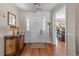 Inviting foyer featuring hardwood floors, a decorative console table, and a welcoming front door at 200 Silverbelle Blvd., Longs, SC 29568