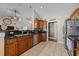 Well-lit kitchen features stainless steel appliances, wooden cabinets and a black countertop at 200 Silverbelle Blvd., Longs, SC 29568