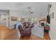 Cozy living room with a fireplace, hardwood floors, and an open layout leading to the dining area at 200 Silverbelle Blvd., Longs, SC 29568