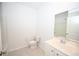 Well-lit bathroom with a single sink vanity, toilet, and a large mirror reflecting the space at 2002 Sweetflag Dr., Longs, SC 29568