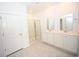 Bright bathroom with double sinks, a shower with glass doors, and tile flooring creating a clean and modern space at 2002 Sweetflag Dr., Longs, SC 29568