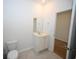 Bathroom with a single sink vanity, toilet, and a mirror reflecting the open doorway at 2002 Sweetflag Dr., Longs, SC 29568