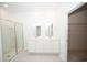 Bright bathroom featuring double sinks, glass shower, and access to a walk-in closet for added convenience and organization at 2002 Sweetflag Dr., Longs, SC 29568