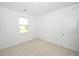 Bright bedroom with a neutral colored carpet and a single window at 2002 Sweetflag Dr., Longs, SC 29568