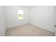 Neutral bedroom with a large window offering natural light and a pleasant view at 2002 Sweetflag Dr., Longs, SC 29568