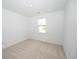Bright bedroom with a window providing a street view and carpet floor at 2002 Sweetflag Dr., Longs, SC 29568