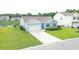 Aerial view of home's exterior with pond and landscaping at 2002 Sweetflag Dr., Longs, SC 29568