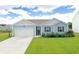 Charming single-story home featuring a two-car garage, manicured lawn, and inviting curb appeal at 2002 Sweetflag Dr., Longs, SC 29568