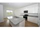 Bright kitchen with granite island, stainless steel appliances, and plenty of counter space at 2002 Sweetflag Dr., Longs, SC 29568