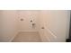 Functional laundry room with essential hookups and neutral tile flooring at 2002 Sweetflag Dr., Longs, SC 29568