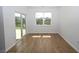 Bright room featuring wood flooring, a sliding glass door, and a window with views of the backyard pond at 2002 Sweetflag Dr., Longs, SC 29568