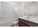 Clean bathroom with a combined shower and tub, a wooden vanity, and a sunny window, creating a refreshing space at 201 Gray Owl Dr., Conway, SC 29527