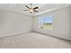 Spacious bedroom with plush carpeting, ceiling fan and a sunny window with neighborhood views at 201 Gray Owl Dr., Conway, SC 29527