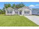 Charming single-story home featuring a well-manicured lawn and a classic gray exterior at 201 Gray Owl Dr., Conway, SC 29527