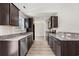 A modern eat-in kitchen with dark wood cabinets, stainless appliances and granite countertops at 201 Gray Owl Dr., Conway, SC 29527