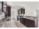 A modern kitchen with dark wood cabinets, stainless appliances and granite countertops at 201 Gray Owl Dr., Conway, SC 29527