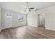 Bright, open living room with hardwood floors and a ceiling fan, featuring a window with natural light at 201 Gray Owl Dr., Conway, SC 29527