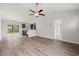 Open-concept living area with hardwood floors, connecting to the kitchen with stainless steel appliances at 201 Gray Owl Dr., Conway, SC 29527