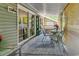 Cozy back porch with outdoor seating and serene views, great for entertaining or unwinding at 201 Surrey Ln., Myrtle Beach, SC 29579