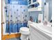 Bathroom featuring a nautical themed shower curtain, white vanity, and wall storage at 201 Surrey Ln., Myrtle Beach, SC 29579