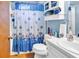 Bright bathroom with a shower and bathtub showcasing a charming starfish-themed shower curtain at 201 Surrey Ln., Myrtle Beach, SC 29579