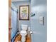 Bathroom featuring a toilet, patterned shower curtain, and wooden framed window at 201 Surrey Ln., Myrtle Beach, SC 29579