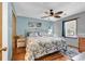 Cozy bedroom with a floral patterned comforter, ceiling fan, and natural light from the window at 201 Surrey Ln., Myrtle Beach, SC 29579