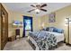 Bedroom featuring a ceiling fan, blue accent drapes, and a mounted television at 201 Surrey Ln., Myrtle Beach, SC 29579