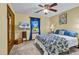 Bedroom featuring a ceiling fan, blue accent drapes, and a mounted television at 201 Surrey Ln., Myrtle Beach, SC 29579