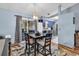 Bright dining area with backyard access, table set for four, flowing into a well-equipped kitchen at 201 Surrey Ln., Myrtle Beach, SC 29579