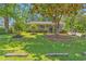 Beautiful home with lush landscaping, a welcoming front porch, and mature trees for shade at 201 Surrey Ln., Myrtle Beach, SC 29579