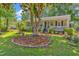 Charming home with a welcoming front porch, lush landscaping, and a beautiful tree-lined yard at 201 Surrey Ln., Myrtle Beach, SC 29579
