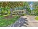 Inviting home featuring a well-maintained lawn, mature trees, and a welcoming front porch at 201 Surrey Ln., Myrtle Beach, SC 29579