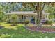 Charming single-story home featuring a welcoming front porch, blue door, and beautifully landscaped yard at 201 Surrey Ln., Myrtle Beach, SC 29579
