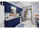Well-equipped kitchen featuring granite countertops, stainless steel appliances, and navy blue cabinetry at 201 Surrey Ln., Myrtle Beach, SC 29579